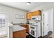 Bright kitchen featuring granite countertops and modern appliances with adjacent dining area at 569 Alexander Farms Sw Vw, Marietta, GA 30064