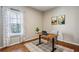 Bright office with wood floors, natural light from the window, modern desk setup and neutral-toned decor at 569 Alexander Farms Sw Vw, Marietta, GA 30064