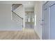 Bright foyer with wood-look floors, staircase, and views into an open-concept living area at 90 Barge Ln, Covington, GA 30016