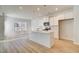 Modern kitchen with island, white cabinets, and stainless steel appliances open to living space at 90 Barge Ln, Covington, GA 30016