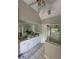 Bathroom featuring double sink vanity, large mirror, and a glass enclosed shower at 1896 Lake Ridge Ter, Lawrenceville, GA 30043