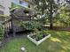 Cozy deck with shade cover, surrounded by lush greenery and garden bed at 1896 Lake Ridge Ter, Lawrenceville, GA 30043