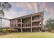 Multi-story brick home showcasing a large backyard with a covered deck and balcony, as well as a lush green lawn at 2146 Greensward Ne Dr, Atlanta, GA 30345