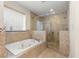 Modern bathroom featuring a soaking tub and glass-enclosed shower with detailed tile work at 2146 Greensward Ne Dr, Atlanta, GA 30345