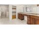 Bright bathroom featuring dual vanities with granite countertop, framed mirror, and tiled walk-in shower at 2146 Greensward Ne Dr, Atlanta, GA 30345