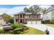 Elegant brick home featuring a three-car garage, manicured lawn, and a charming double-door entrance at 2146 Greensward Ne Dr, Atlanta, GA 30345