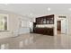 Spacious kitchenette with wood cabinets, stainless steel refrigerator, sink, and adjacent door and window at 2146 Greensward Ne Dr, Atlanta, GA 30345