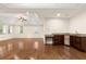 Open-concept living room featuring hardwood floors, kitchenette with granite countertop, recessed lighting, and windows at 2146 Greensward Ne Dr, Atlanta, GA 30345