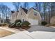 Side view of an elegant home featuring an attached garage, manicured landscaping, and a paved driveway at 2986 Sedgewick Pl, Marietta, GA 30062