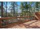 Spacious wood deck with black metal railings, ideal for outdoor entertaining with wooded view at 4206 Townsend Ln, Atlanta, GA 30346