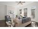 Bright living room featuring a stone fireplace, ceiling fan and plush seating at 4206 Townsend Ln, Atlanta, GA 30346