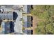 Overhead view of townhome community with mature trees and ample parking spaces for residents and visitors at 907 Redwood Dr, Norcross, GA 30093