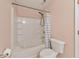 Bright bathroom featuring a combination tub and shower with a white shower curtain at 907 Redwood Dr, Norcross, GA 30093
