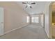 Serene bedroom with large windows, ceiling fan, and access to an adjoining bathroom at 907 Redwood Dr, Norcross, GA 30093