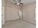 Bright bedroom featuring neutral carpeting, a ceiling fan, and access to an en-suite bathroom at 907 Redwood Dr, Norcross, GA 30093
