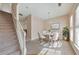 Cozy dining area with a modern chandelier, stylish furnishings, and access to the stairway at 907 Redwood Dr, Norcross, GA 30093