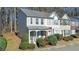 Attractive exterior elevation of townhouse with tidy landscaping, covered front porch, and neutral color scheme at 907 Redwood Dr, Norcross, GA 30093