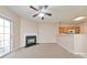 Cozy living room with fireplace and sliding doors, adjoining kitchen with wooden cabinets at 907 Redwood Dr, Norcross, GA 30093