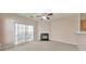 Bright living room with fireplace, sliding doors, and view of the kitchen area at 907 Redwood Dr, Norcross, GA 30093