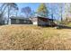 Wide view of the backyard featuring a gentle slope and partial view of the house at 217 Woodglen Dr, Woodstock, GA 30188