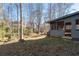 A sloped backyard with the exterior of the home on a sunny day at 217 Woodglen Dr, Woodstock, GA 30188