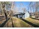 Exterior view of home featuring blue siding, a covered porch and surrounding yard with mature trees at 217 Woodglen Dr, Woodstock, GA 30188