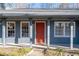 Inviting front porch area with well-maintained siding and red door with a brick walkway at 217 Woodglen Dr, Woodstock, GA 30188