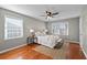 Serene main bedroom with hardwood floors, windows and a comfortable king-size bed at 217 Woodglen Dr, Woodstock, GA 30188