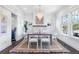 Elegant dining room featuring a modern chandelier, with a new dining table and windows with grids at 634 Delmar Se Ave, Atlanta, GA 30312