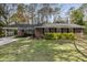 Charming brick home featuring a well-manicured lawn, classic shutters, and a convenient carport at 6830 Sunny Brook Ln, Atlanta, GA 30328