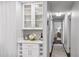 Hallway features built-in hutch with glass door cabinets and marble countertops at 6830 Sunny Brook Ln, Atlanta, GA 30328