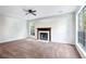 Spacious carpeted living room with a fireplace, ceiling fan and plenty of natural light at 1017 Dover Way, Norcross, GA 30093