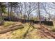 Large, landscaped backyard with a garden bed and a partial view of a blue house at 1101 United Se Ave, Atlanta, GA 30316