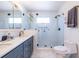 Well-lit bathroom featuring a double sink vanity, glass shower, and a large mirror at 1101 United Se Ave, Atlanta, GA 30316