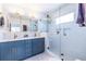 Bright bathroom with a double sink vanity, glass shower, and decorative mirror at 1101 United Se Ave, Atlanta, GA 30316