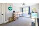 Bright bedroom featuring a bunk bed, grey walls, carpeted floors, and natural light from the window at 1101 United Se Ave, Atlanta, GA 30316