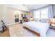 Bright bedroom featuring a spacious bed, work space, stylish rug, and access to ensuite bathroom at 1101 United Se Ave, Atlanta, GA 30316