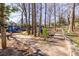 Community playground with a modern blue playset offering slides and climbing structures along paved walkways surrounded by trees at 1101 United Se Ave, Atlanta, GA 30316