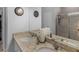 Neutral bathroom featuring a dual sink vanity with granite counters and ample lighting at 122 Delilah St, Mcdonough, GA 30252