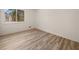 Bedroom features large window, neutral paint, new baseboards, and new laminate wood flooring at 130 Valley Rd, Stockbridge, GA 30281