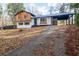 Inviting home featuring unique exterior with carport and well-maintained lawn at 130 Valley Rd, Stockbridge, GA 30281