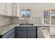 Features include gray cabinets, stainless dishwasher, granite counters, undermount sink and hardwood flooring at 130 Valley Rd, Stockbridge, GA 30281