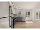 Bright kitchen features gray cabinets, stainless appliances, granite counters, and wood floors at 130 Valley Rd, Stockbridge, GA 30281