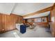 Spacious living room with wood paneled walls, stone fireplace, and vintage Smeg refrigerator at 130 Valley Rd, Stockbridge, GA 30281