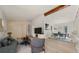 Bright living room featuring a vaulted ceiling with beam, and an open dining area at 130 Valley Rd, Stockbridge, GA 30281