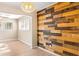 Spacious living room area featuring hardwood floors, decorative chandelier, and a unique wood accent wall at 1603 Bridgeport Dr, Atlanta, GA 30318