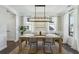 Bright dining area featuring a long table, seating for six, and large windows at 315 Edinburgh Ln, Woodstock, GA 30188