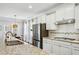 Modern kitchen with granite countertops, stainless steel refrigerator, and white subway tile backsplash at 315 Edinburgh Ln, Woodstock, GA 30188