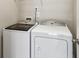 This laundry room features a modern, side-by-side washer and dryer set at 315 Edinburgh Ln, Woodstock, GA 30188