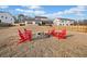 Backyard fire pit area with Adirondack chairs provides a cozy spot for outdoor relaxation and gatherings at 169 Aspen Hall Dr, Canton, GA 30115